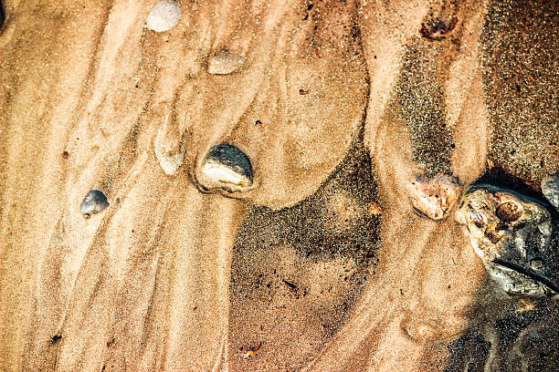 istock Golden sand wraps around the stones 479040568