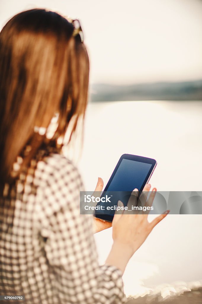 Young woman using digital tablet outdoors 2015 Stock Photo