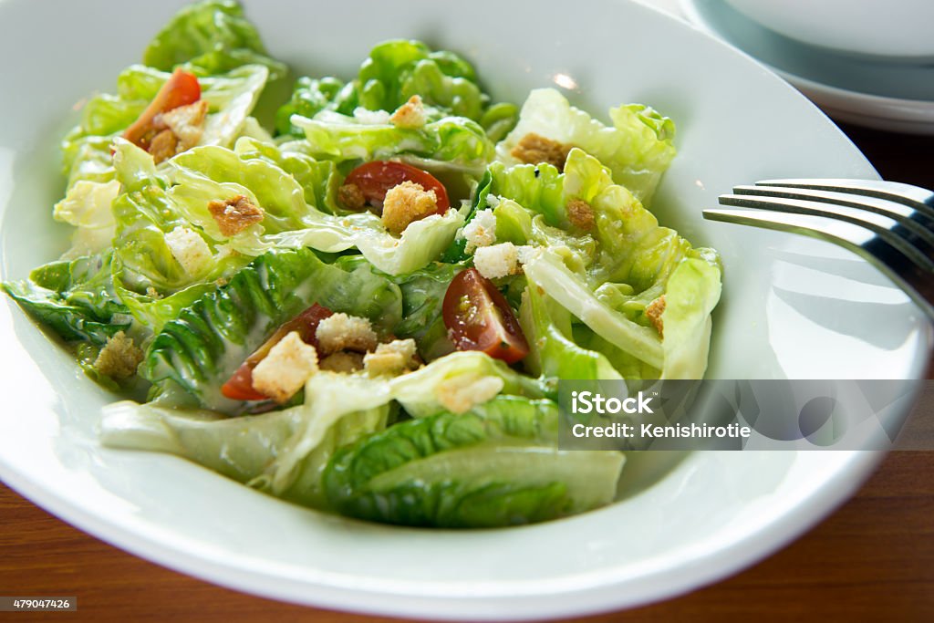 Caesar salad Bowl of Caesar salad with a fork Green Salad Stock Photo