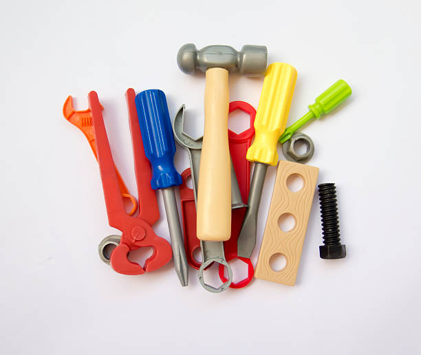 colored set of plastic tools, gathered in a pile on a white background