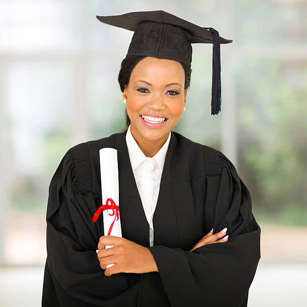 istock female african graduate with arms crossed 479047522