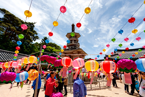 Gyeongiu, South Korea - May 17, 2013: People are visiting the Bulguksa Temple where hanging lanterns for celebrating the Buddha's birthday, Gyeongiu, South Korea. Buddha’s birthday is major event on the Lunar calendar in Korea. 