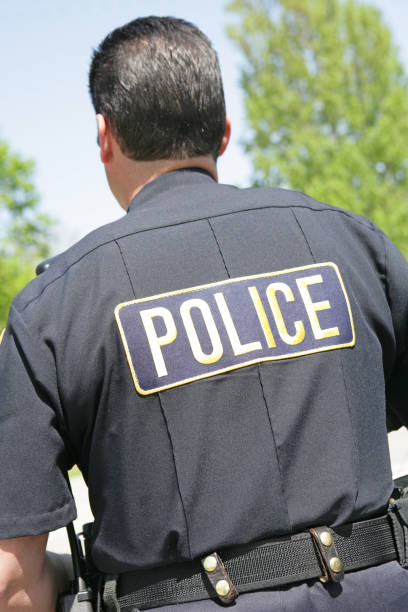 istock Police Officer From Behind Vertical 479056157