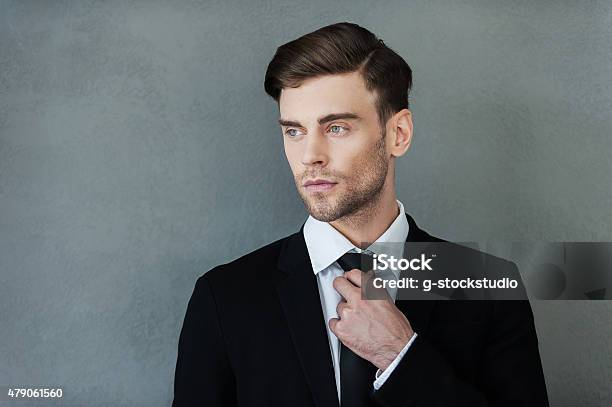 Confident Businessman Stock Photo - Download Image Now - 20-29 Years, 2015, Adjusting