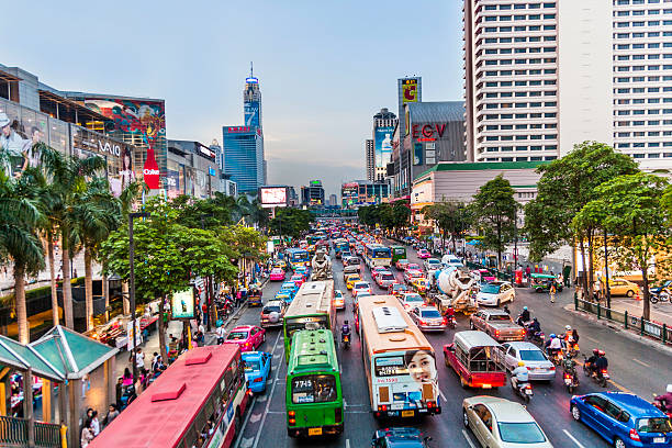 Bangkok cityscape and traffic in sunset Bangkok, Thailand - May 7, 2009: Bangkok cityscape and traffic in sunset with illuminated cars and buildings. Bangkok is famous for its heavy traffic in the city centre. silom stock pictures, royalty-free photos & images