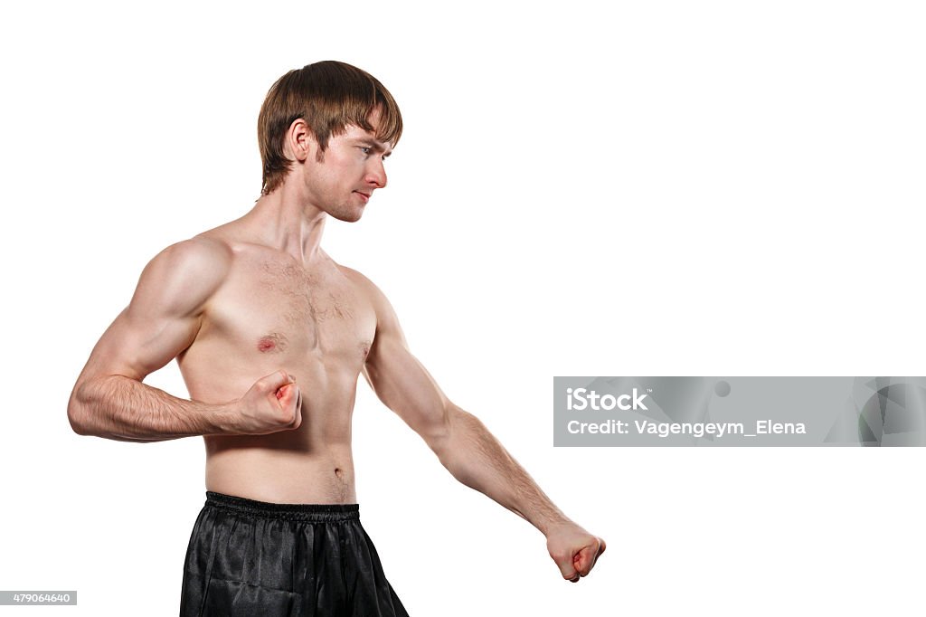 Taekwondo Fighter The man trains kata taekwondo. Isolated on white background. The concept of masculine strength and a healthy lifestyle. 2015 Stock Photo