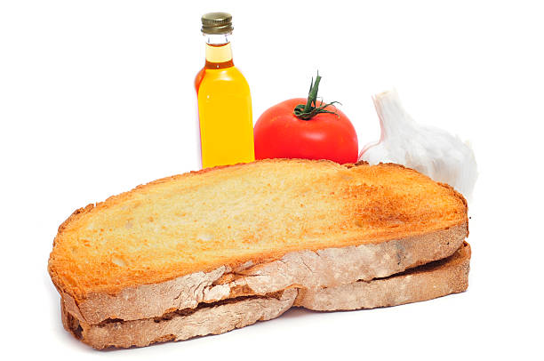 toasted bread, tomato, garlics and olive oil to make pa amb tomaquet, bread with tomato, typical of Catalonia, Spain