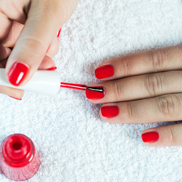 istock Beautiful woman's nails with red polish on soft white towel. 479069998