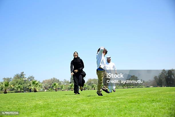 Arab Emirati Family Outdoors In Park Stock Photo - Download Image Now - 2015, Active Lifestyle, Activity