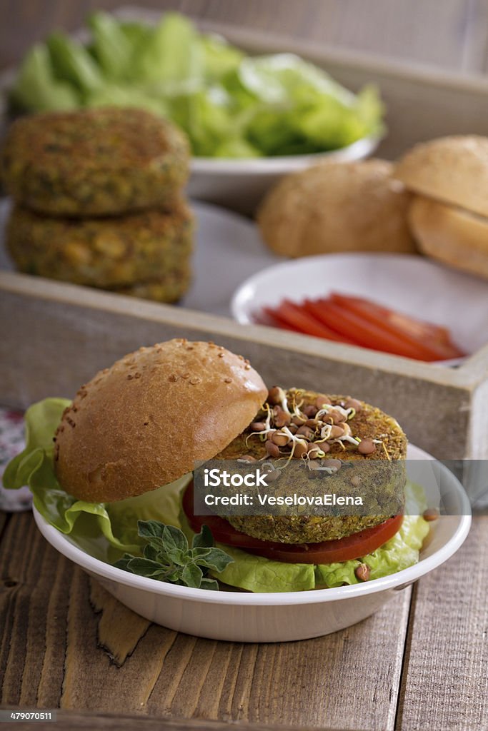 Vegan burgers with chickpeas and vegetables Vegan burgers with chickpeas served with fresh vegetables Backgrounds Stock Photo