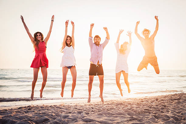 istock Group of five friends jumping on beach 479073018