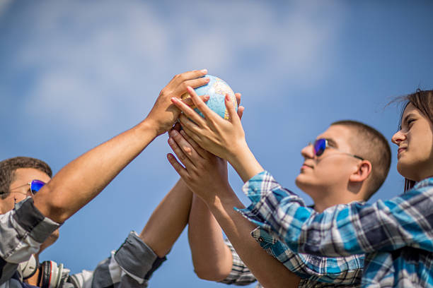 istock Friends holding the world 479073064
