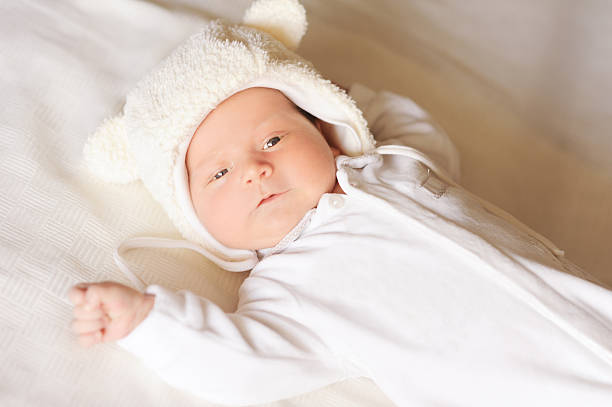 istock Cute baby boy lying in bed 479073371