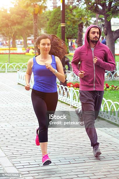 Young Couple Jogging In The City Stock Photo - Download Image Now - 20-29 Years, 2015, Active Lifestyle