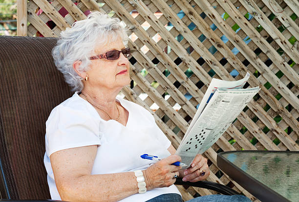 istock Senior woman doing crossword puzzles 479077503