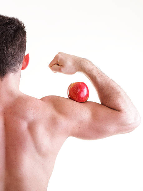 istock Athletic sexy male body builder holding red apple 479083503