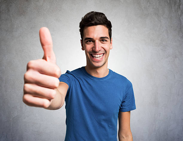 istock happy smiling man giving thumbs up 479084398
