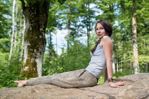 Foot pain .Woman sitting on grass Her hand caught at the foot. Having painful feet and stretching muscles fatigue To relieve pain. health concepts.