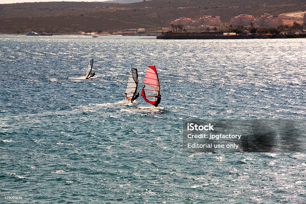 three wind surfers on the sea izmir, Turkey - June 25, 2015: three wind surfers sailing on the aegean sea, coast of İzmir in golden hours 2015 Stock Photo