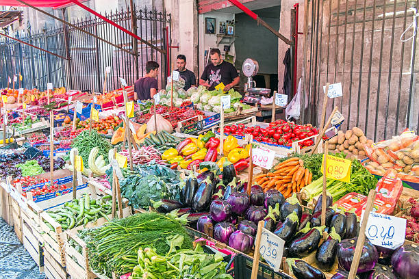 Palermo, Italy – June 9, 2015: Fruits and vegetables for sale at Mercato il Capo in Palermo, Sicily. This is one of several popular open-air street markets in Palermo. Palermo is more than 2700 years old with a rich and diverse history and culture.