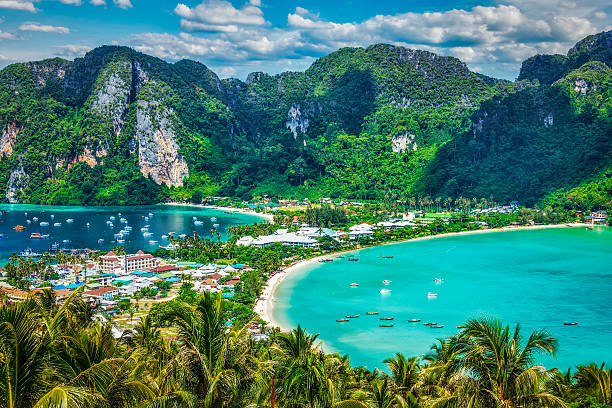 Green tropical island Travel vacation background - Tropical island with resorts - Phi-Phi island, Krabi Province, Thailand phi phi islands stock pictures, royalty-free photos & images