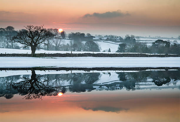 istock Snow covered Winter countryside sunrise landscape reflected in s 479101332