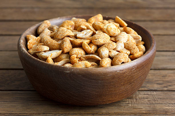 istock Rustic spicy dry roasted peanuts in rustic wood bowl. 479104866