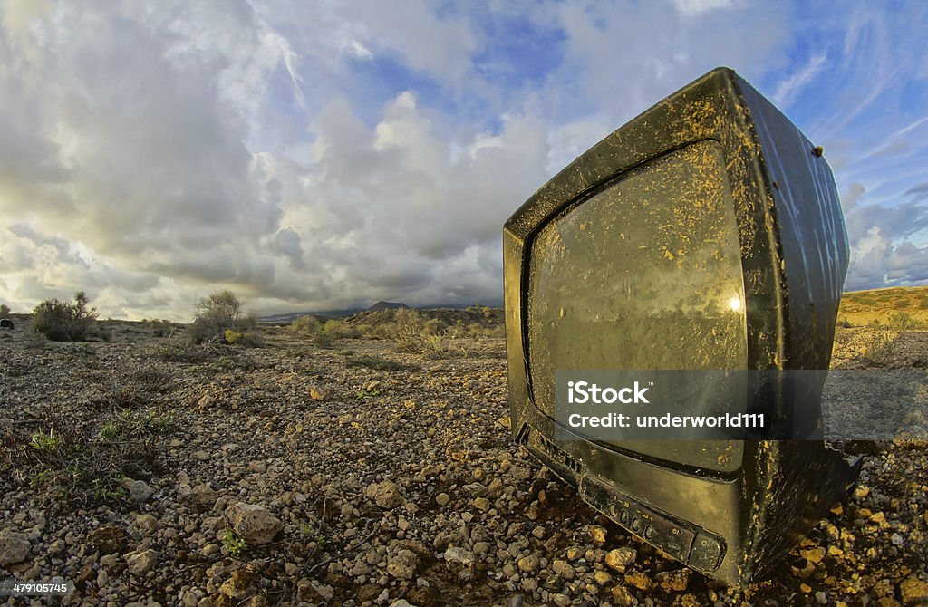 Abandoned Broken Television Abandoned Broken Television in the Desert on a Cloudy Day Analog Stock Photo