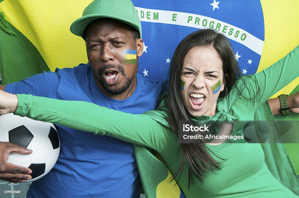 Fans cheering Brazil at a Football Match Fans cheering Brazil at a football match. Adolescence Stock Photo