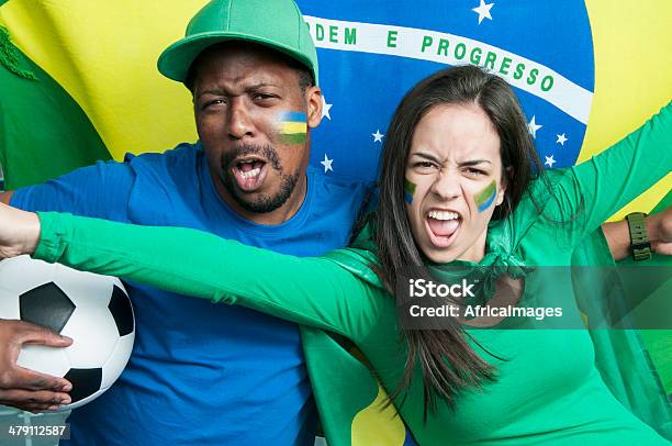 Fans Cheering Brazil At A Football Match Stock Photo - Download Image Now - Adolescence, Adult, Arms Outstretched