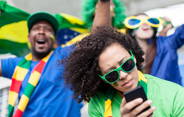 istock Brazilian fan on her phone while at a soccer match. 479112643