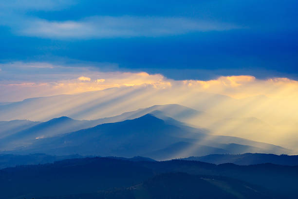 Sunbeams lighing mountain landscape stock photo