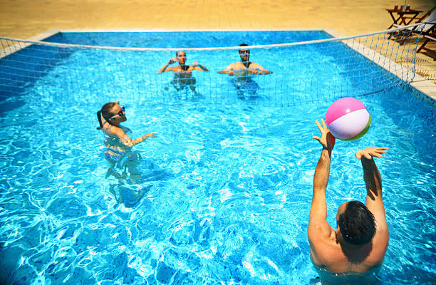 istock Friends playing volleybay in a pool. 479115512