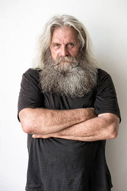 istock senior man with long hair and beard portrait 479115582