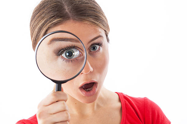 istock Young woman with a magnifying glass 479116141