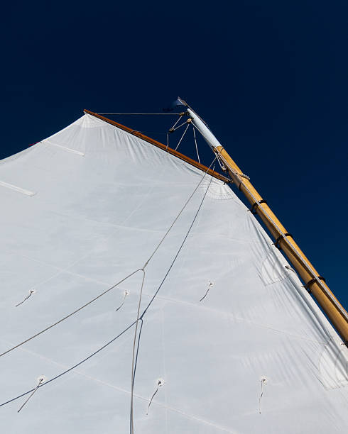 Gaff Rigged sail on a Catboat The gaff rigged sail and masthead of a catboat under sail. gaff rigged stock pictures, royalty-free photos & images