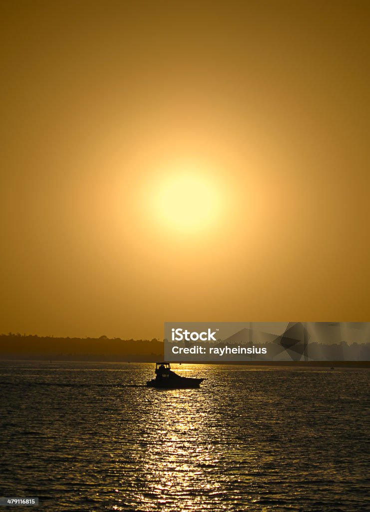 Boat under the sunset Silhouette of a boat under the sunset in San Diego. California Stock Photo