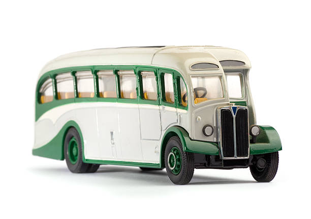 Old metal scale model of a public bus isolated on white.