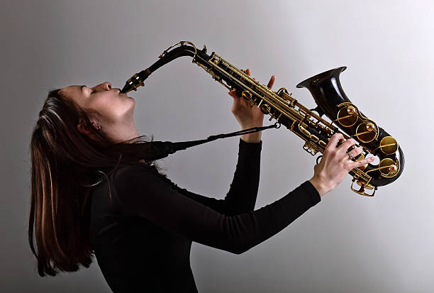 istock woman in black with saxophone 479127313