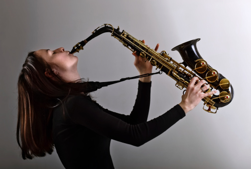 young woman in black with saxophone.