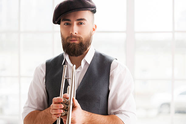 Ready for improvising. Handsome young bearded men standing with trumpet in his hands man trumpet stock pictures, royalty-free photos & images