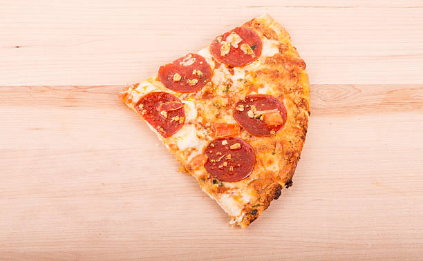 istock Slice of Pepperoni Pizza on a Wood Cutting Board 479130297