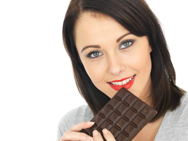 istock Young Woman Holding Dark Plain Chocolate on Her Red Lip 479131956