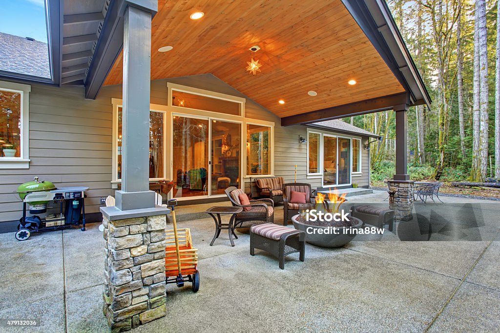 Large back yard with grass. Large back yard with grass and covered patio with firepit. Fire Pit Stock Photo