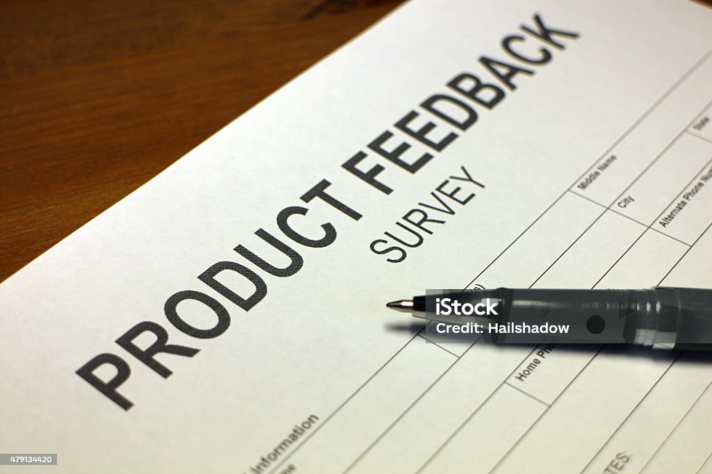Product Feedback Survey Someone filling out Product Feedback Survey. 2015 Stock Photo
