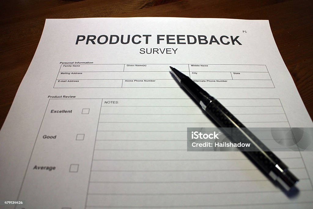 Product Feedback Survey Form Someone filling out Product Feedback Survey. 2015 Stock Photo