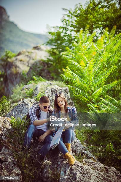 Couple Using Tablet On The Mountain Stock Photo - Download Image Now - Digital Tablet, E-Reader, Summer