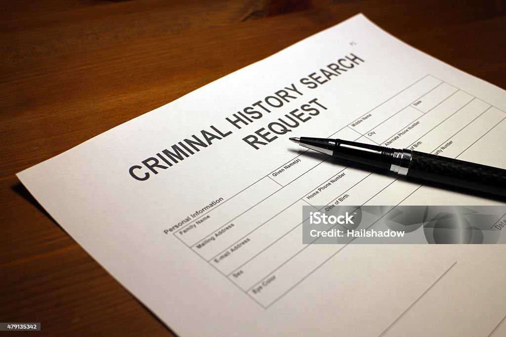 Criminal History Search Document Someone filling out Criminal History Search Request. Examining Stock Photo