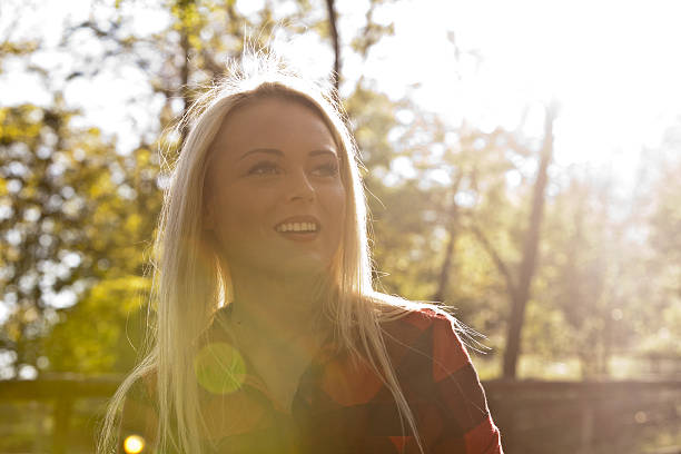 istock backlight blonde woman in the park 479136006