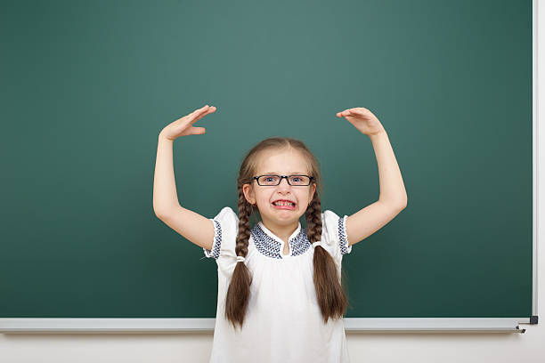 istock Schoolgirl near school board 479143028